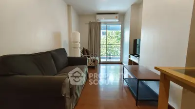 Spacious living room with modern furniture and balcony view in a stylish apartment.