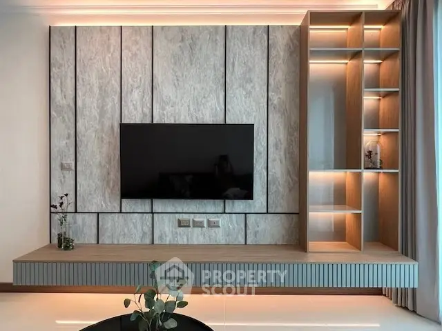 Modern living room with sleek TV wall unit and ambient lighting