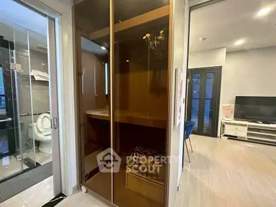 Modern apartment interior with glass-enclosed sauna and open living area