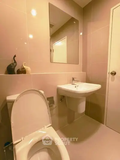 Modern bathroom with sleek fixtures and neutral tiles