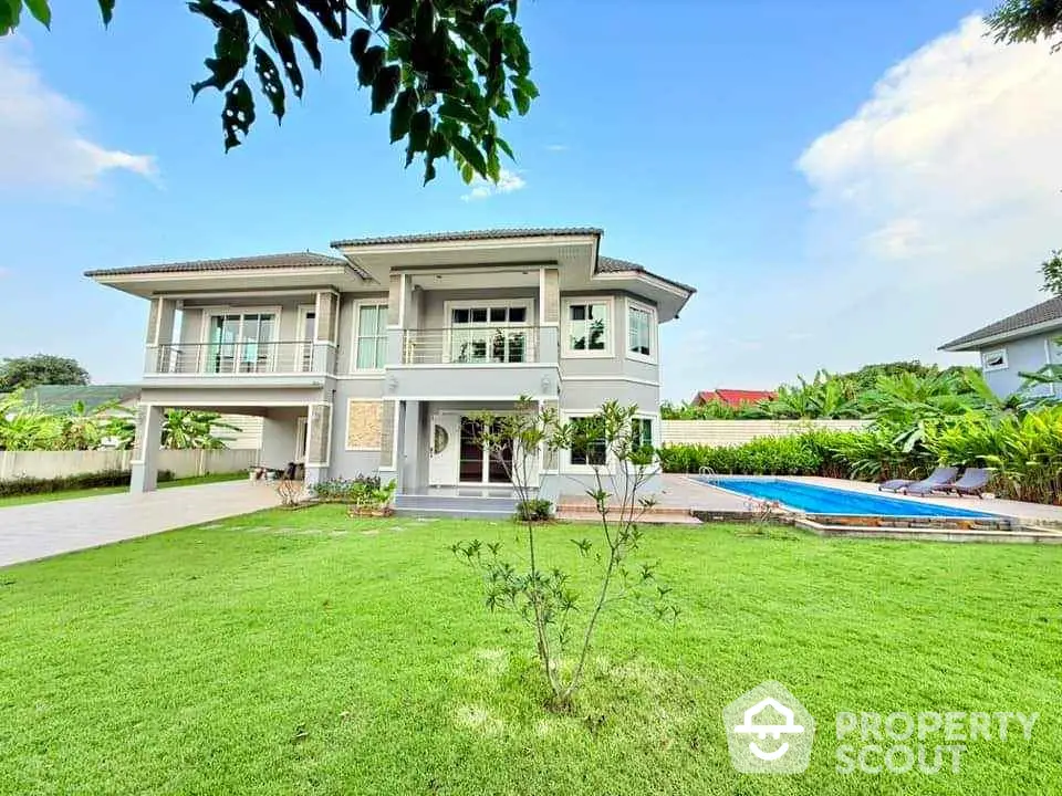 Luxurious two-story house with spacious garden and private pool in serene neighborhood.