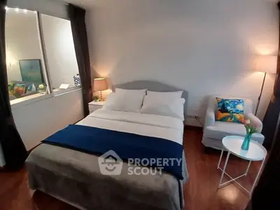 Cozy bedroom with elegant decor and natural lighting, featuring a comfortable bed and stylish furnishings.