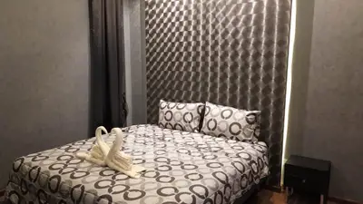 Cozy bedroom with modern decor and elegant bedding in a stylish apartment.