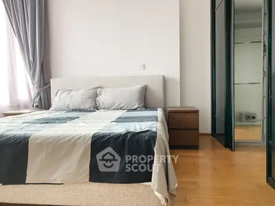 Spacious bedroom with modern decor and ample natural light