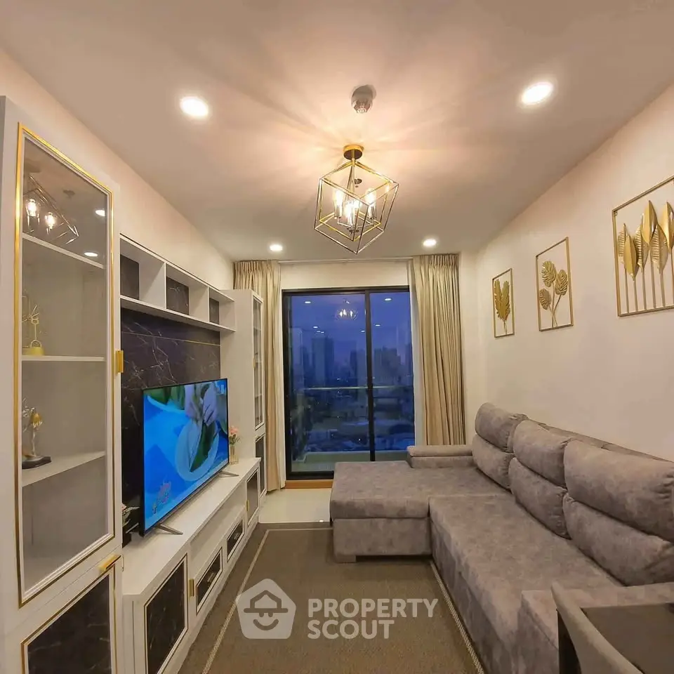 Luxurious living room with modern decor and city view, featuring a plush sectional sofa and elegant lighting.