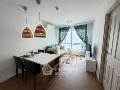 Charming living room with natural light, cozy seating, and stylish dining area in modern apartment.