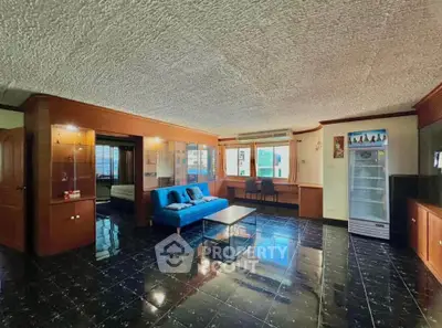 Spacious living room with modern decor and large windows for natural light.