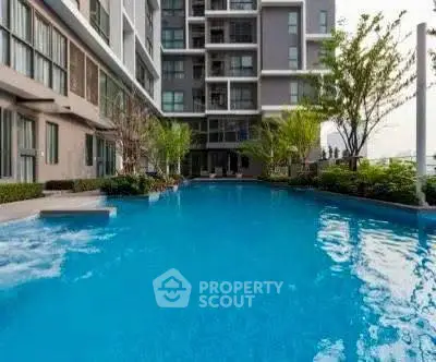 Luxurious apartment complex with stunning pool and modern architecture.