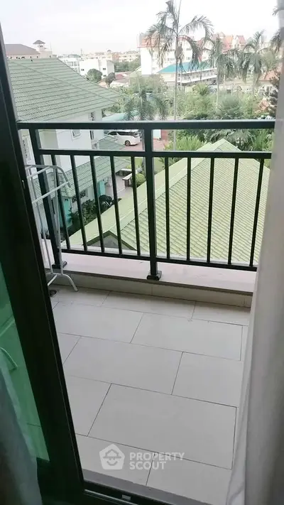 Charming balcony with city view and lush greenery, perfect for relaxation and enjoying the outdoors.