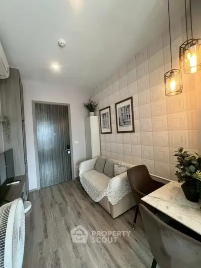 Stylish living room with modern decor and cozy seating area, perfect for relaxation.