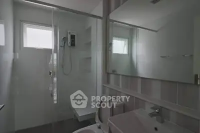 Modern bathroom with glass shower and sleek fixtures