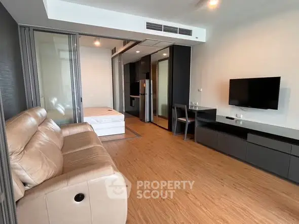 Modern living room with sleek furniture and open layout in a stylish apartment.