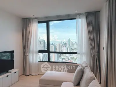 Modern living room with panoramic city view and elegant decor.