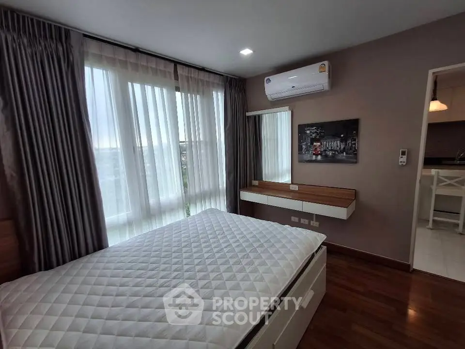 Modern bedroom with large windows and air conditioning in stylish apartment