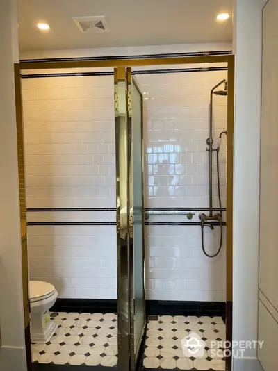 Elegant bathroom with modern shower and classic tile design