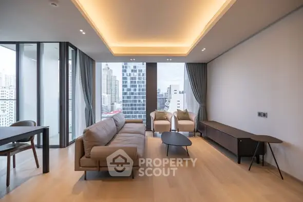 Modern living room with city view, featuring sleek furniture and floor-to-ceiling windows.