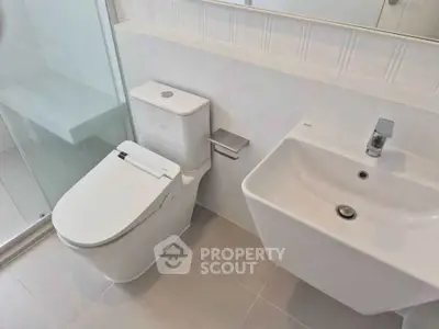 Modern bathroom with sleek fixtures and glass shower enclosure