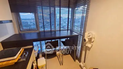Cozy kitchen nook with city view, featuring a breakfast bar and modern seating.