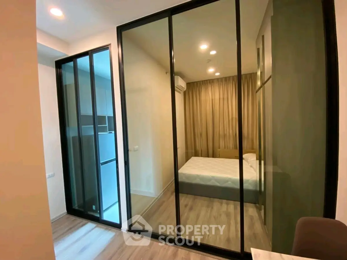 Modern bedroom with glass partition and cozy lighting in stylish apartment