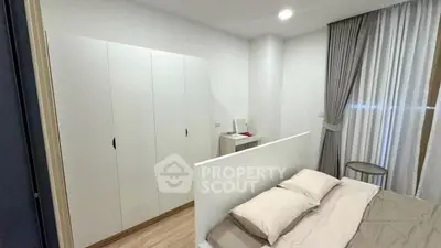 Modern bedroom with sleek wardrobe and cozy bed setup