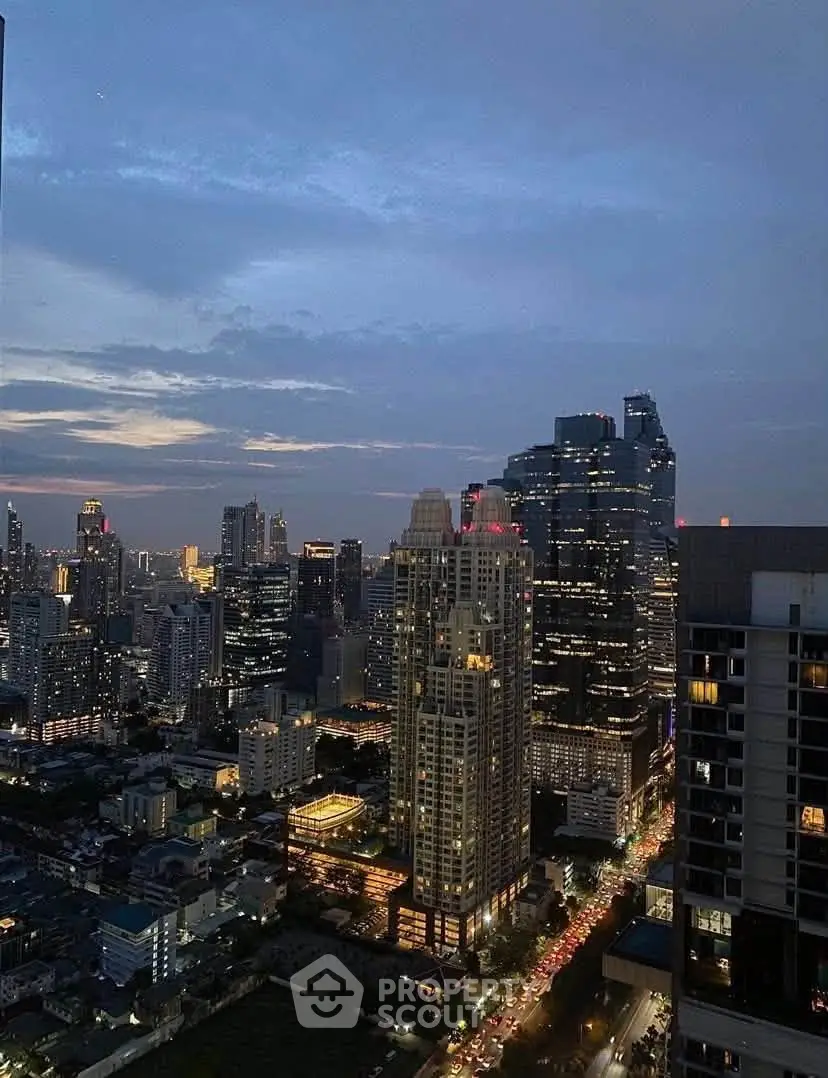 Stunning cityscape view from a high-rise building at dusk, showcasing vibrant urban skyline.