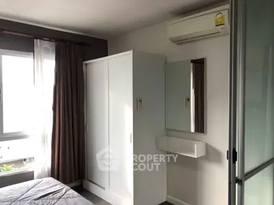 Cozy bedroom with air conditioning and modern wardrobe, perfect for comfortable living.