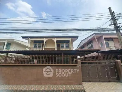 Charming two-story house with gated entrance and spacious balcony in a serene neighborhood.