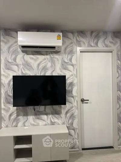 Modern living room with stylish wallpaper and mounted TV