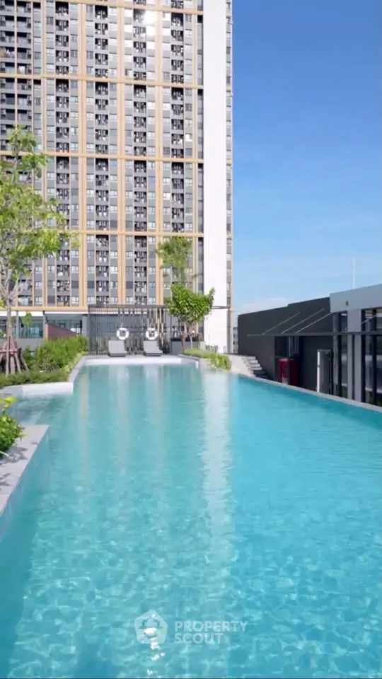 Luxurious high-rise building with stunning rooftop pool and city views.