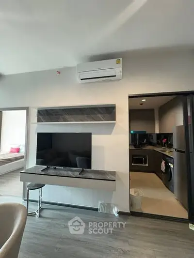 Modern living room with open kitchen layout and sleek design