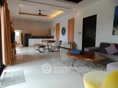 Spacious modern living room with open kitchen and stylish decor