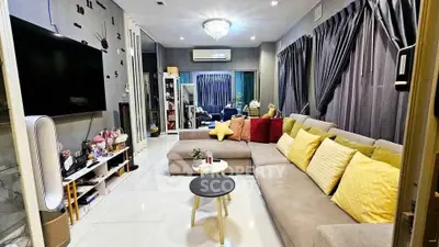 Spacious living room with modern decor and large sectional sofa, perfect for family gatherings.