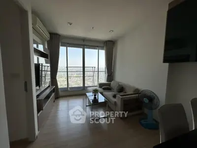 Modern living room with city view, stylish furniture, and natural light.