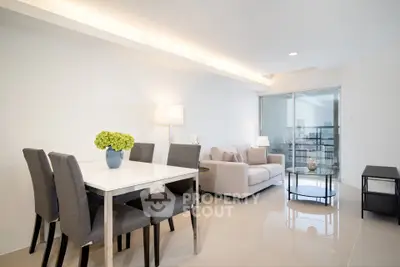 Modern living room with elegant dining area and cozy seating, featuring sleek furniture and bright lighting.