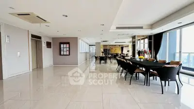 Spacious modern common area with elegant dining setup and city view.