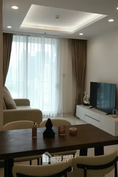 Modern living room with elegant decor and large window offering city view