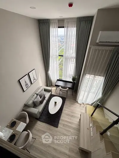Stunning high-ceiling living room with panoramic city view and elegant decor.
