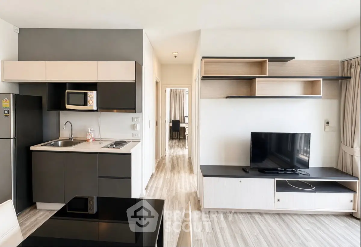 Modern open-layout kitchen and living room with sleek cabinetry and stylish shelving.