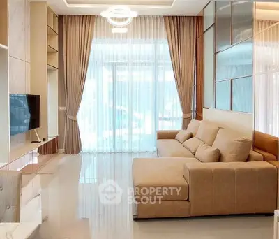 Elegant living room with modern beige sofa and floor-to-ceiling windows, perfect for relaxation.