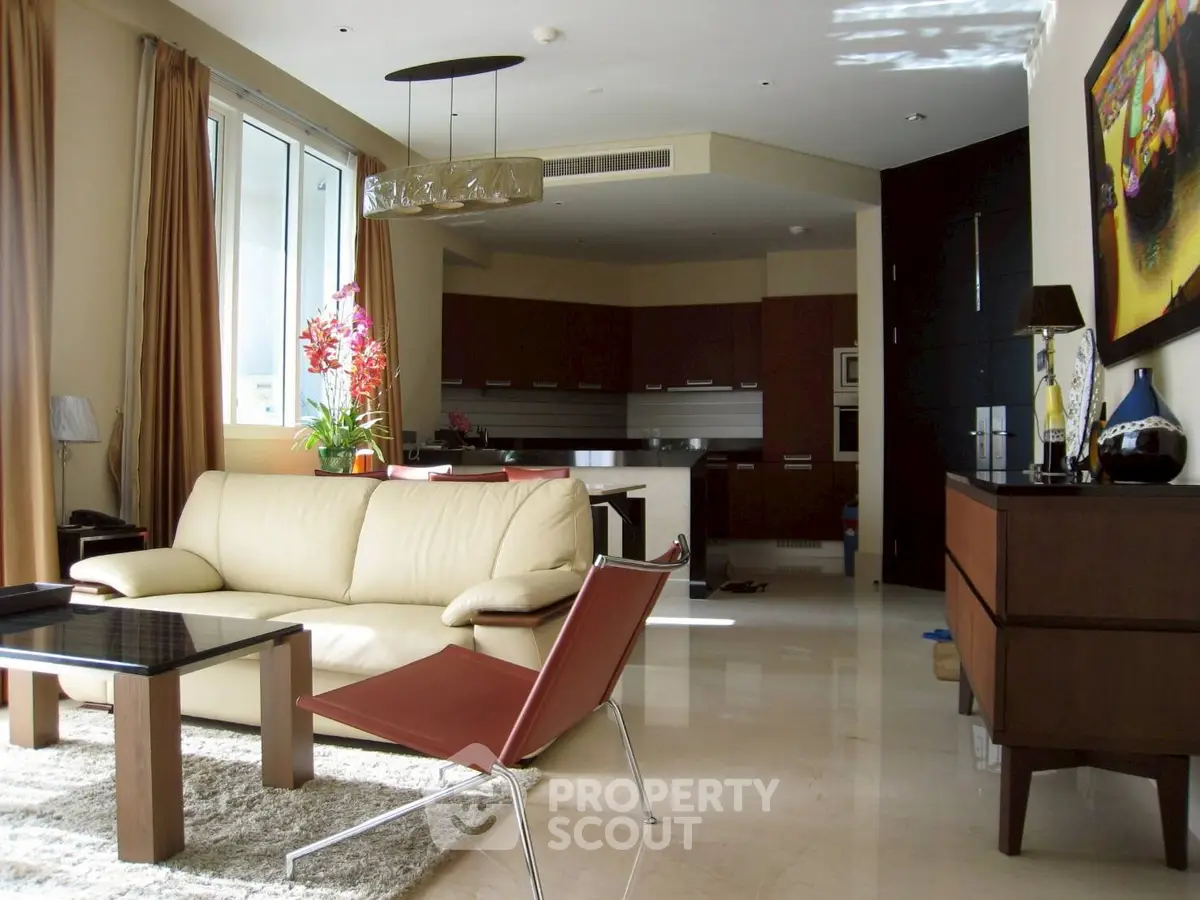 Luxurious modern living room with elegant furniture and open kitchen layout, perfect for stylish urban living.