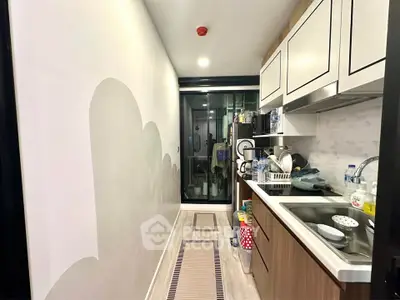 Modern kitchen with sleek cabinetry and open layout in a contemporary apartment.