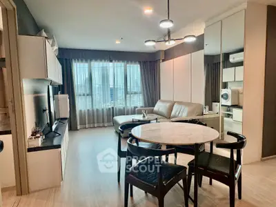 Modern living room with stylish furniture and large window offering city view