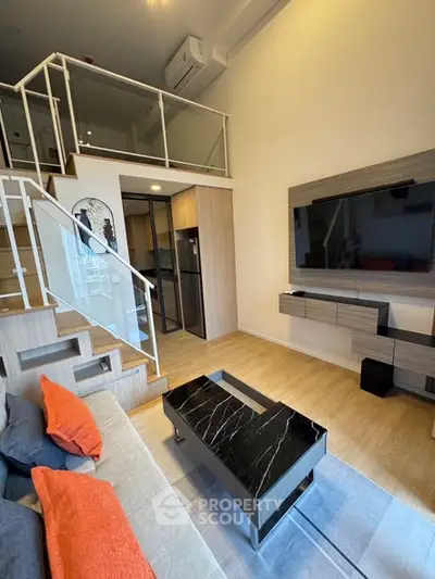 Modern duplex living room with stylish decor and loft area