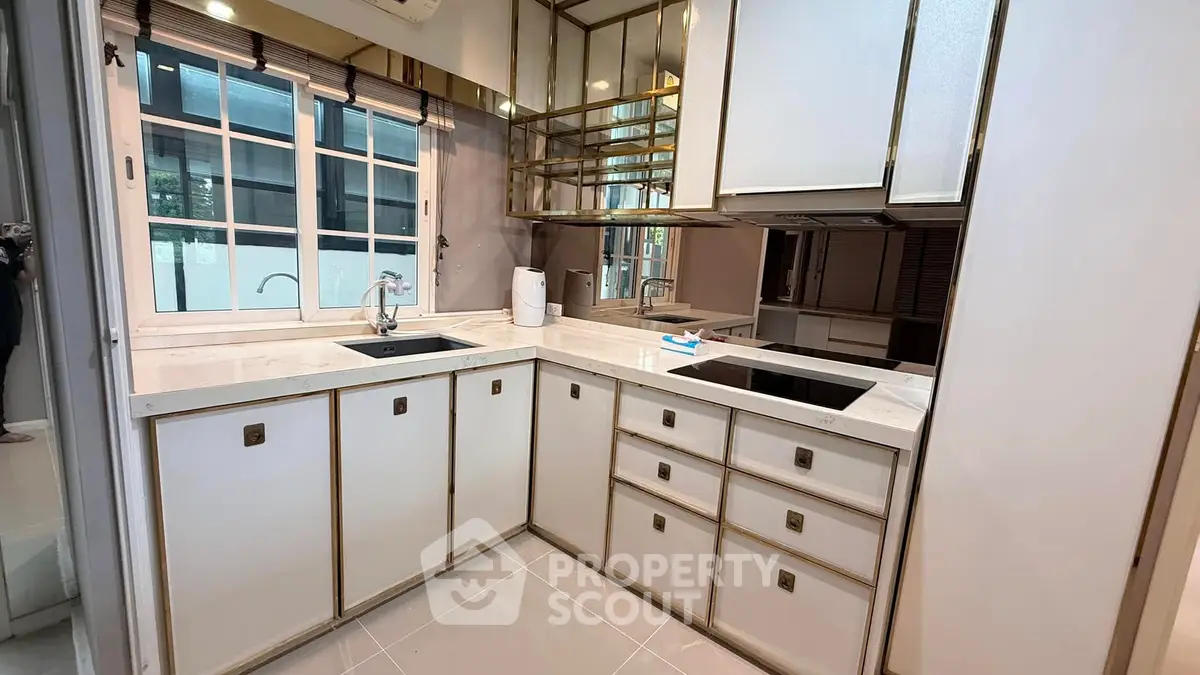 Modern kitchen with sleek cabinetry and built-in appliances in a stylish apartment.