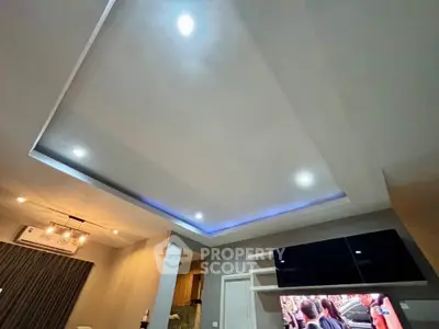 Modern living room with recessed lighting and sleek TV setup