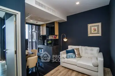 Modern living room with stylish decor and open kitchen layout in a chic apartment.