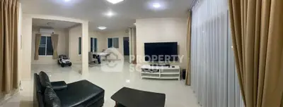 Spacious modern living room with sleek furniture and large windows for natural light.