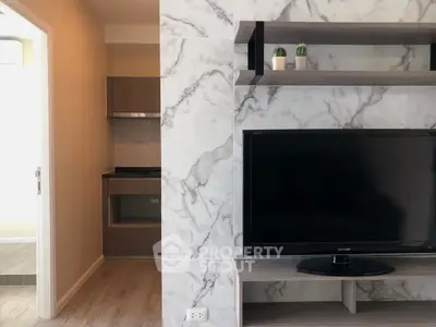 Modern living room with marble accent wall and sleek TV setup