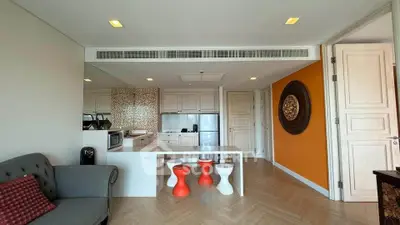 Modern living room with stylish kitchen, featuring open layout and contemporary decor.