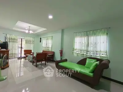 Spacious living room with modern furniture and large windows in a bright, airy home.